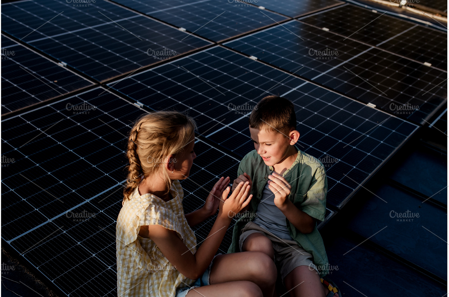 Two young siblings sitting on roof, a Technology Photo by HalfPoint