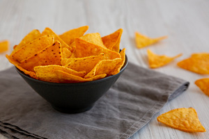 Crunchy Nacho BBQ Tortilla Chips in a Bowl, side view. Close-up., a Food & Drink Photo by LiudmylaChuhunova