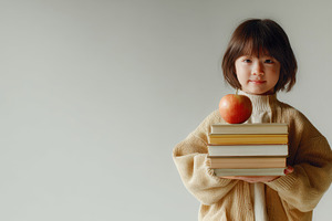 Child with books and an apple, a Photo by Beautiful things
