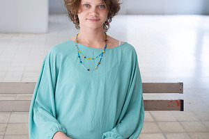 A young woman with curly brown hair, a Person Photo by Imaginarium