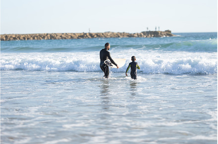 A family of surfers - father and son, a Person Photo by Barcelona_dreams