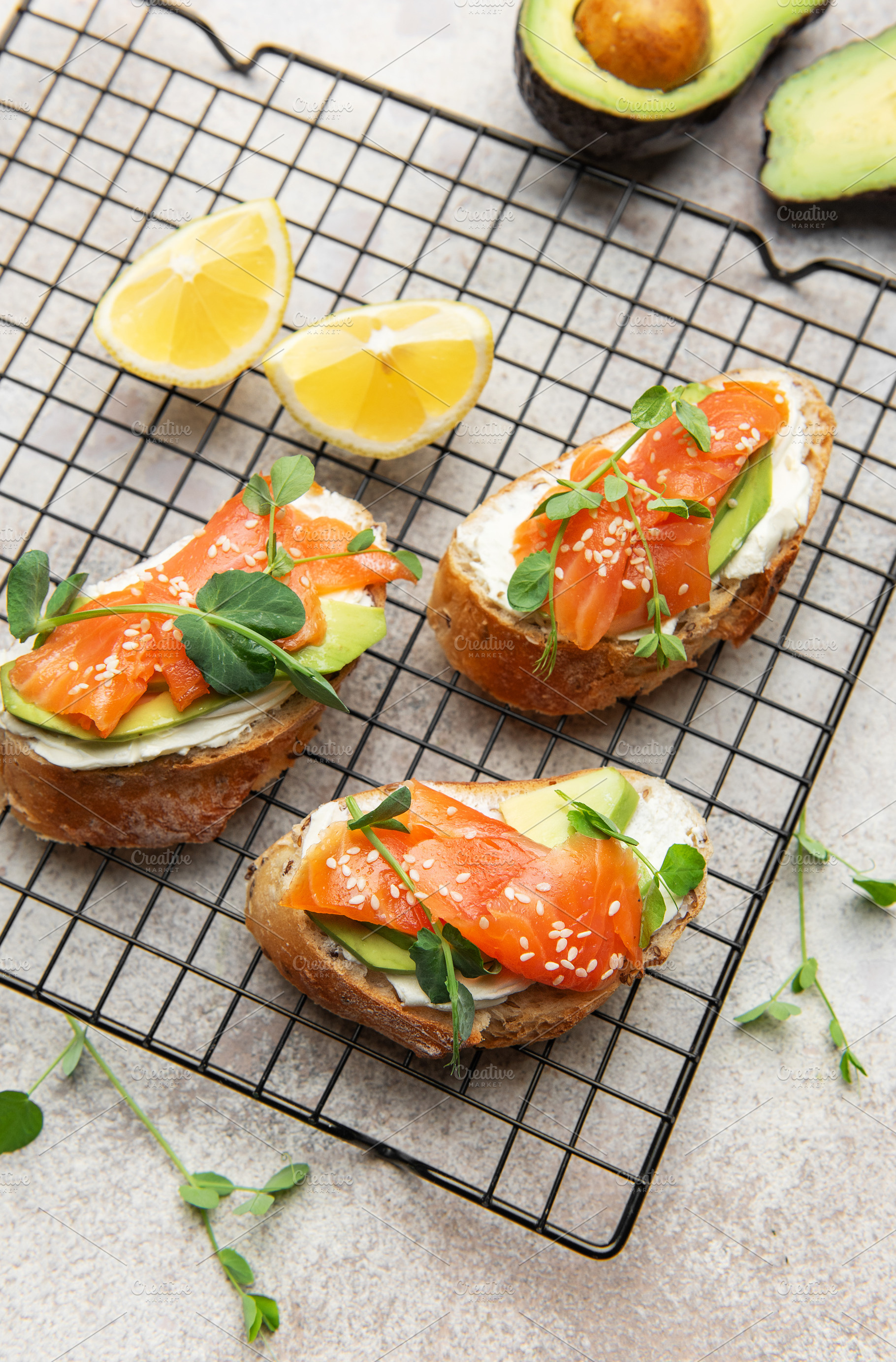 Salmon avocado toasts with microgreens and sesame seeds, a Food & Drink Photo by Olena Rudo