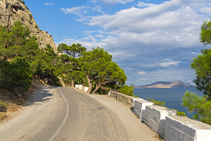 A mountain road along the seashore stock photo containing pine and relic