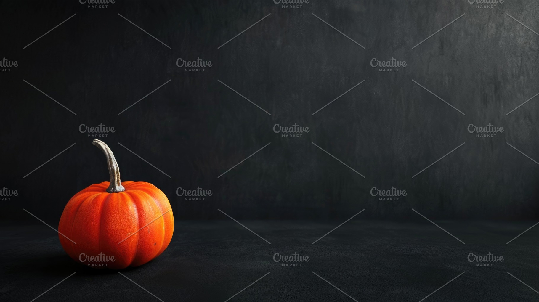 Single orange pumpkin on dark black background with copy space, a Food & Drink Photo by José Manuel Gelpi