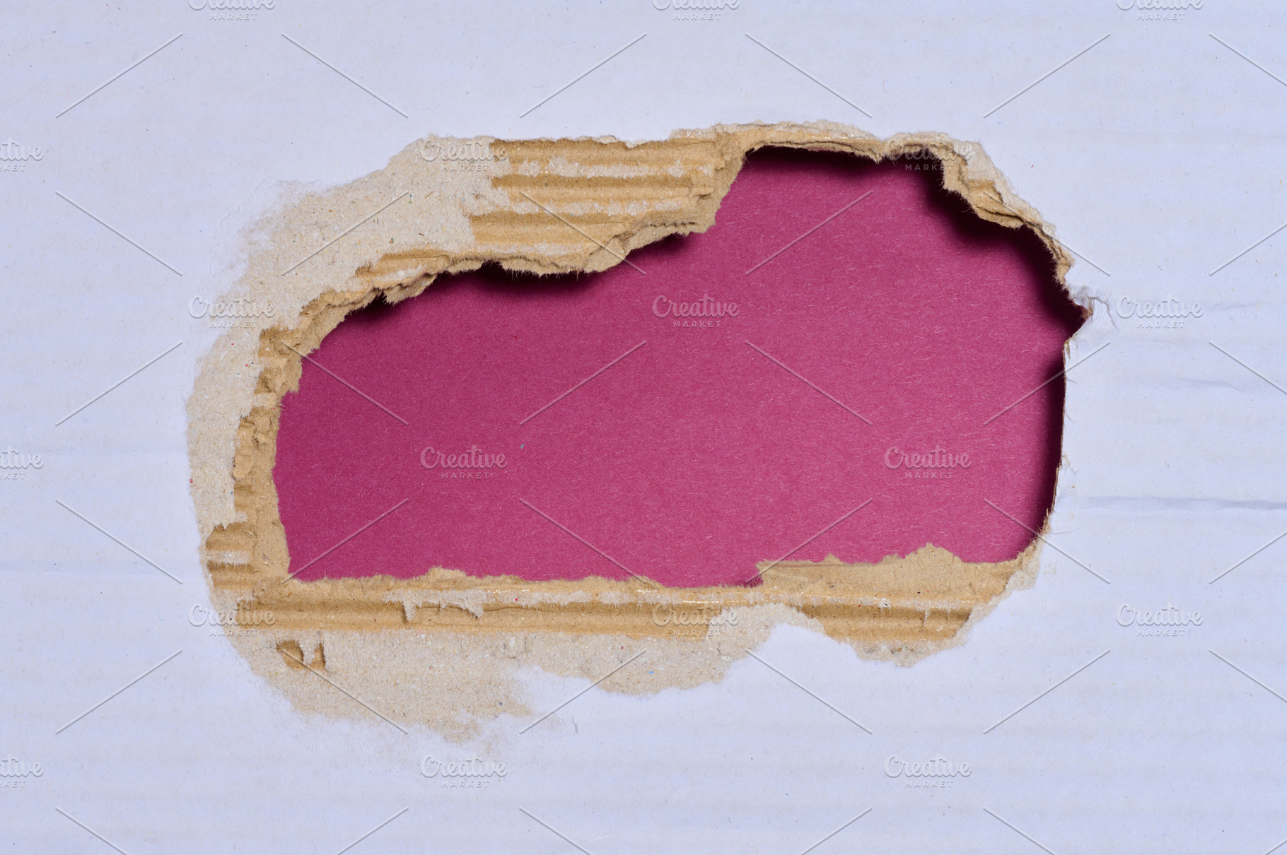 A torn hole in the white cardboard, the inner corrugated layers, a Background Photo by ndanko