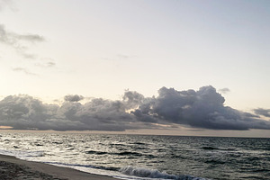 Serene Florida Pensacola beach at sunset with gentle waves and dramatic clouds, a Nature Photo by AS photostudio