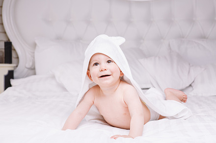 Adorably baby lie on white towel in bed happy childhood and healthcare, a Person Photo by fotoliza