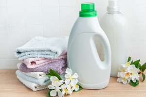 Detergent and fabric softener with fresh laundry towels and flow, an Industrial Photo by Olena Rudo