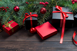 Black and red christmas gift box with red ribbon and fir bran, a Holiday Photo by vimart