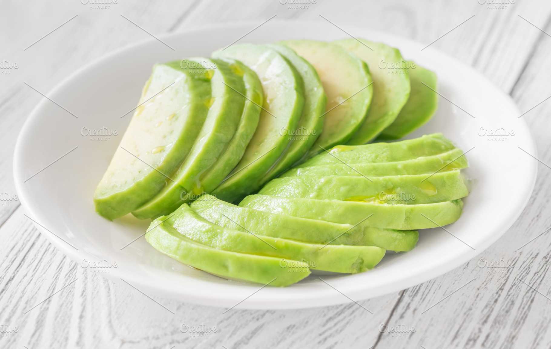 Ripe avocado sliced in white bowl, a Food & Drink Photo by Alexander Prokopenko