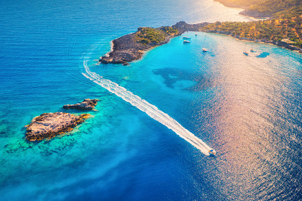 Aerial view of beautiful speed boat on the sea at sunset, a Nature Photo by den-belitsky