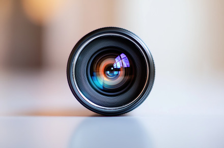 A close-up of a camera lens with a colorful reflection in the glass, showcasing, a Photo by Textures & Backgrounds
