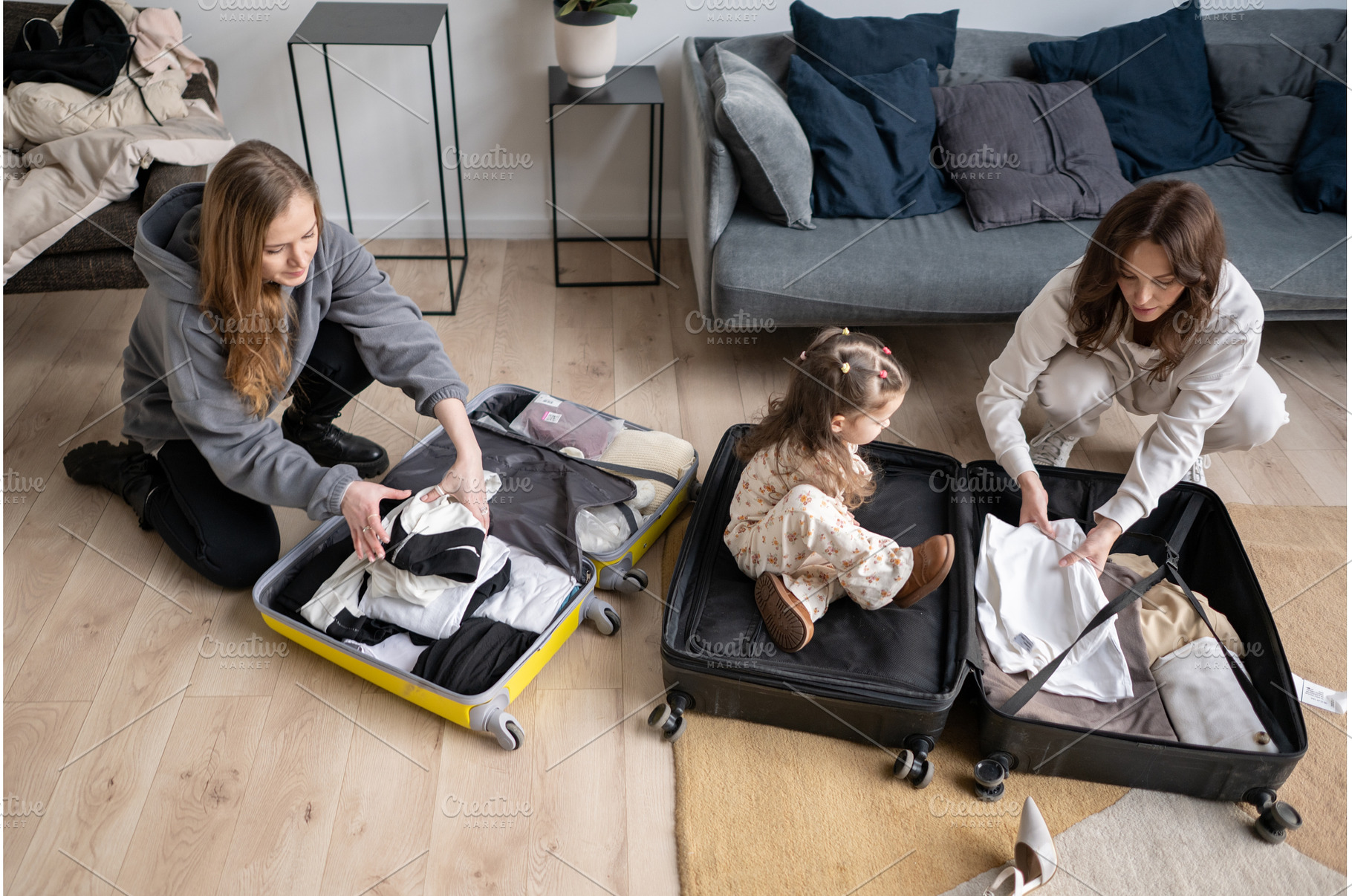 Two women and a little girl packing, an Architecture Photo by undrey