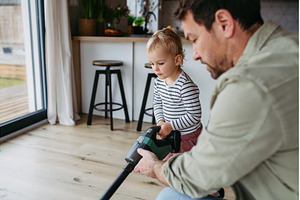 Little boy and dad vacuuming floors, a Person Photo by HalfPoint
