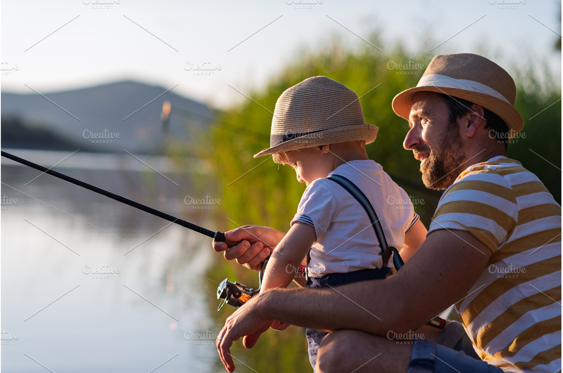 Dad teaching his little boy how to, a Person Photo by HalfPoint