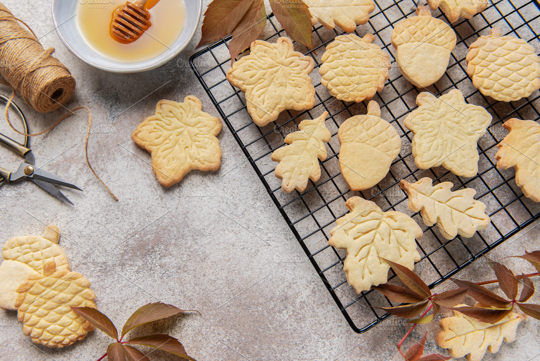 Autumn cookies on wire rack with honey and leaves, a Food & Drink Photo by Olena Rudo