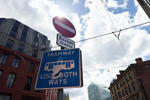 Tramway sign and no entry symbol on a cloudy street in Mancheste, a Photo by AS photostudio