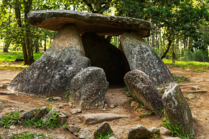 Megalithic stone dolmen in a green f, an Architecture Photo by Perpis