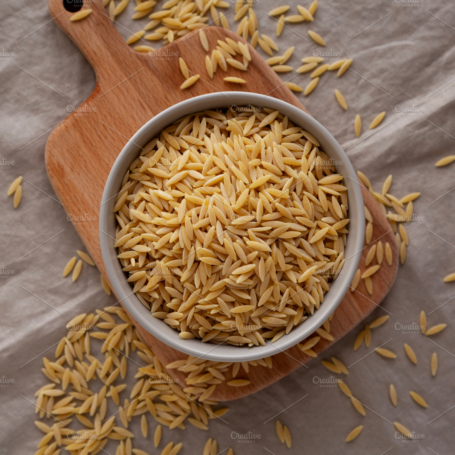 Organic Dried Orzo Pasta in a Bowl, top view. Close-up., a Food & Drink Photo by LiudmylaChuhunova