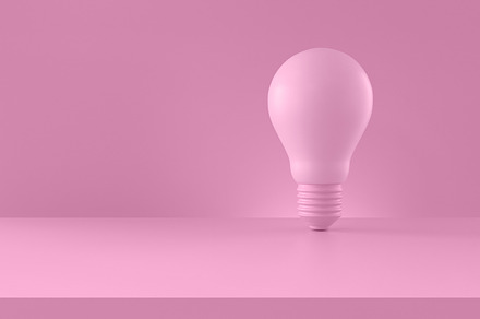 Light bulb on pink background., a Business Photo by Zama Studio