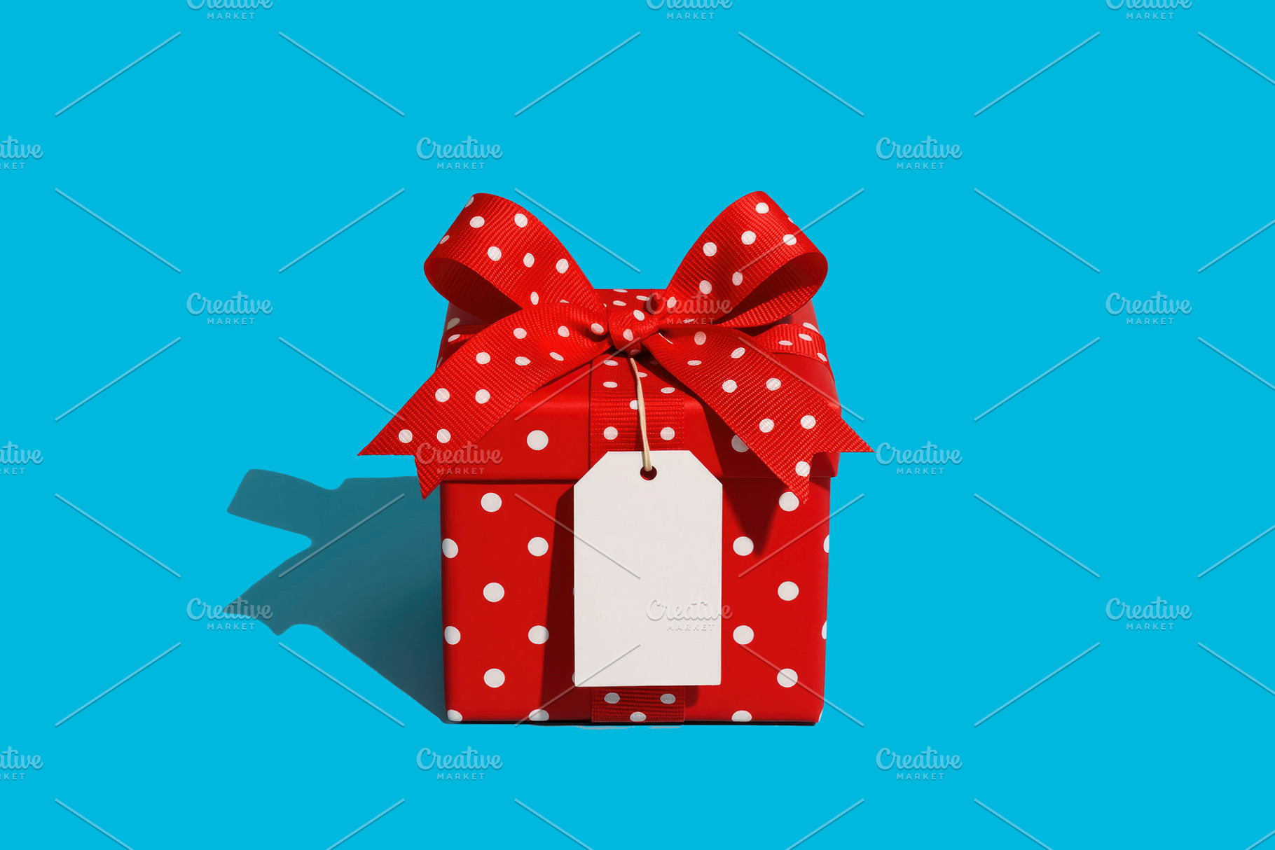a red gift box with a tag, generative AI, a Photo by Nito