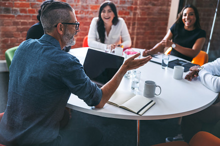 Mature businessman leading a meeting in a modern workplace, a Person Photo by Jacob Lund
