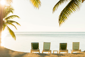 Sunset Over Tropical Beach Deckchairs, a Holiday Photo by THP Creative