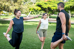 Fitness friends stretching together before an outdoor workout in a park, a Sports & Recreation Photo by etorres69
