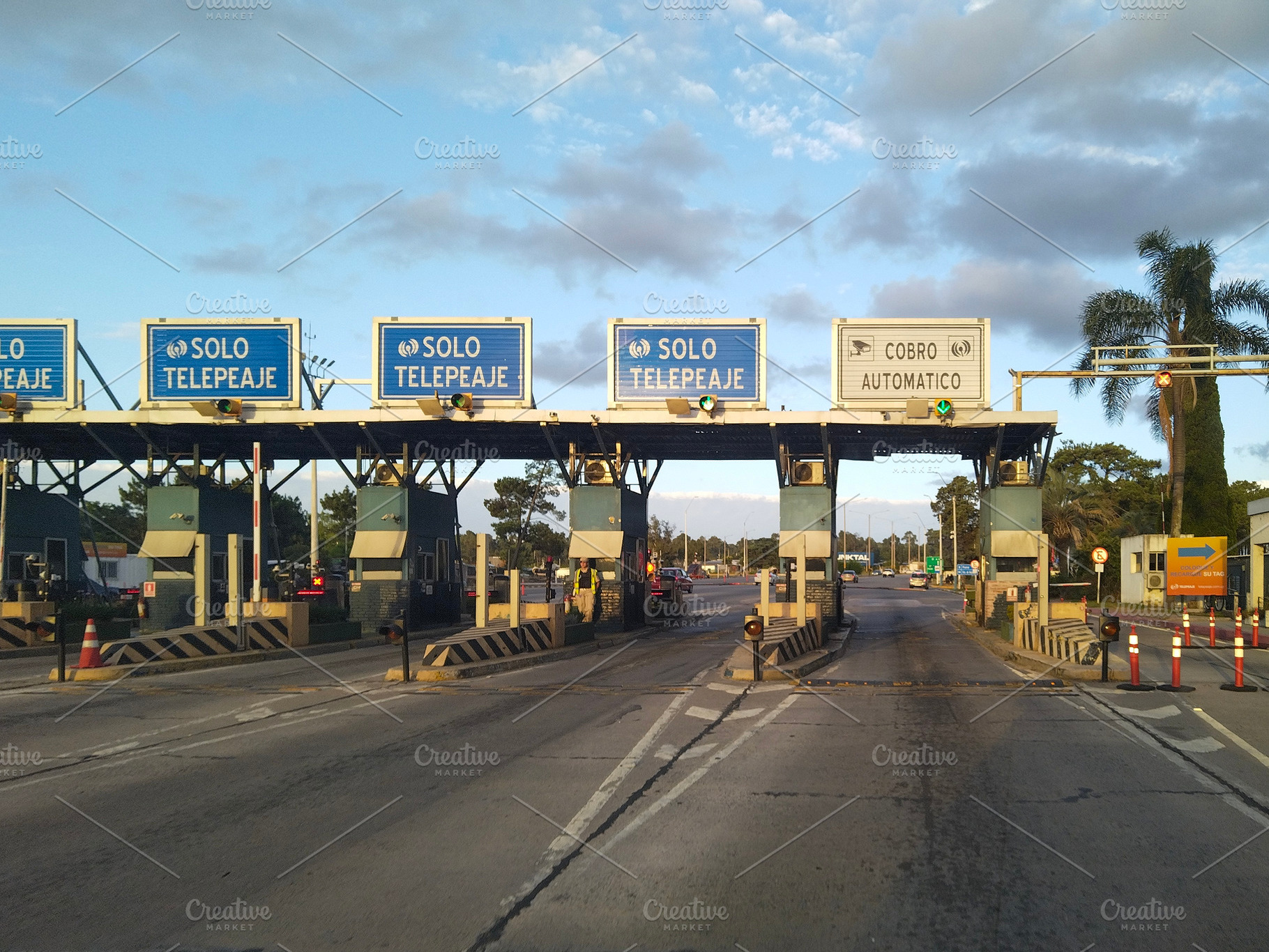 Toll booth under a blue cloudy sky, canelones, uruguay, a Transportation Photo by DanFLCreativo