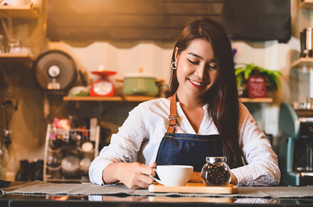 Asian female barista making cup of coffee. Young woman holding w, a Person Photo by Ministocker