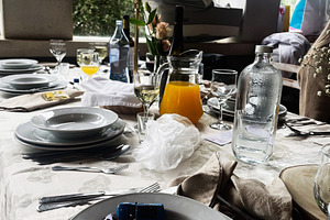 Table setting with dishes, toy cars, and decorations by a bright window, a Photo by AS photostudio