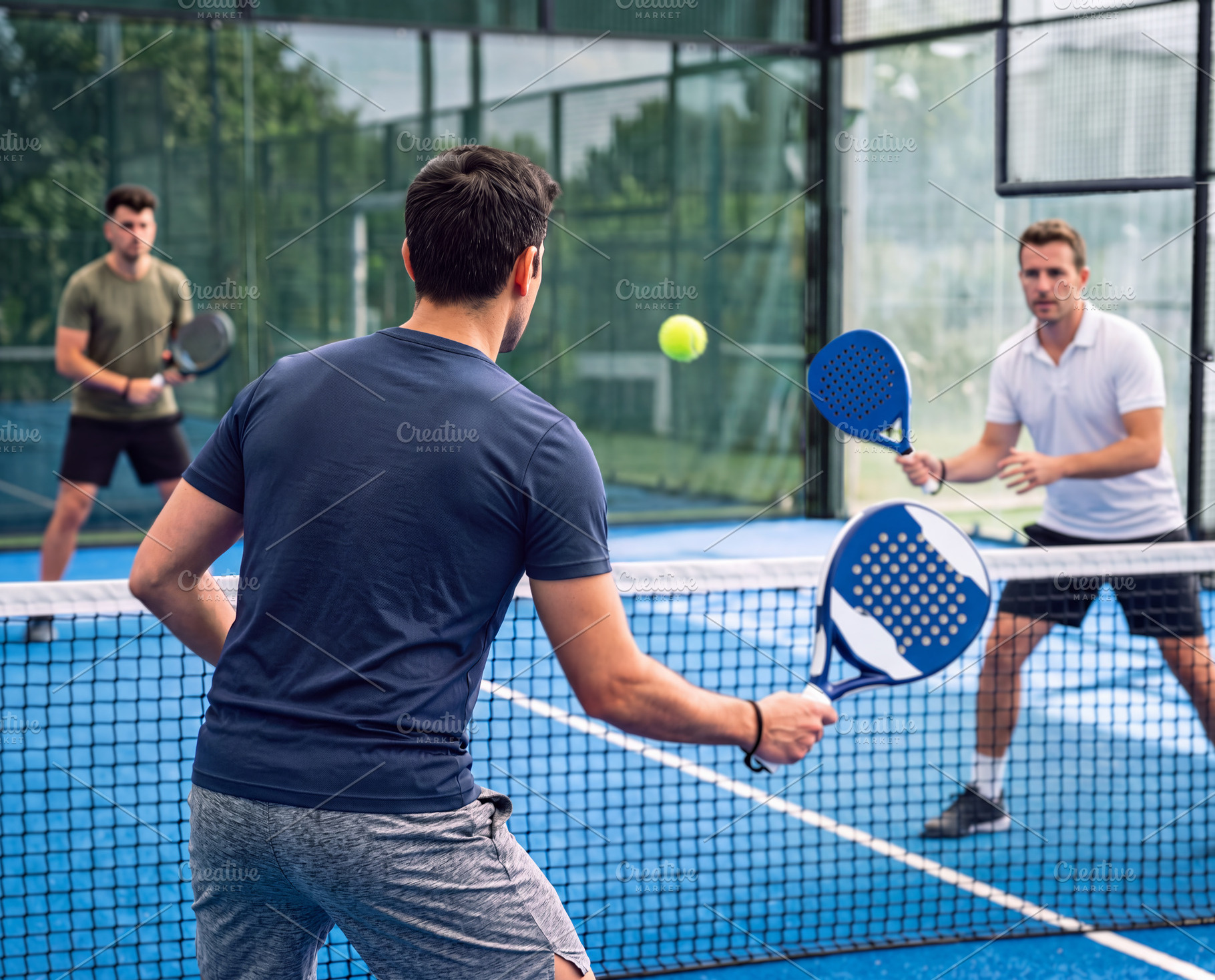 Rear view of focused padel player during dynamic match rally on, a Sports & Recreation Photo by Volff