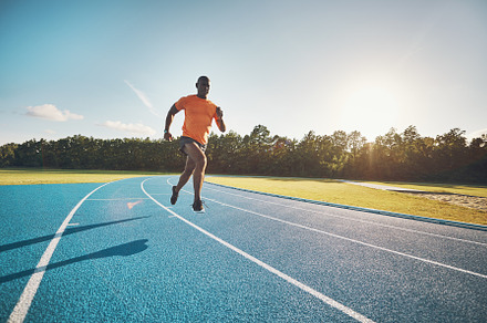 Fit young athlete sprinting down an stock photo containing adults and african, a Sports & Recreation Photo by Stefan & Janni