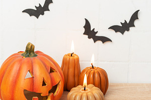Halloween pumpkin jack o lantern with lit candles and spiders