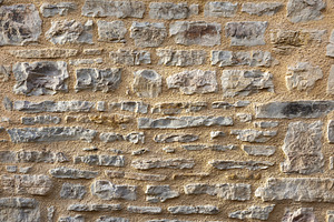 Wall of gray stones held together with brown cement, an Abstract Photo by Davizro's Market