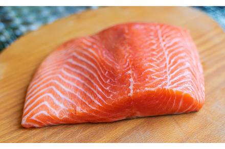 Red fish fillet cutting on the board, a Food & Drink Photo by yanadjana