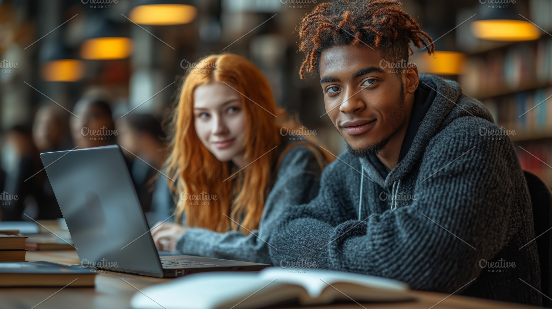 A young Black male student smiles at the camera while working alongside a red-h, a Person Photo by ImageMir