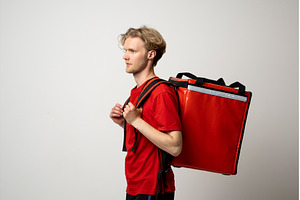Side profile of courier in red, a Person Photo by volodymyrshtun13795