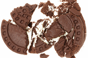 Broken chocolate chip cookies with white cream filling on white, a Food & Drink Photo by ndanko
