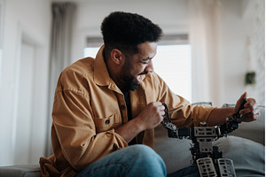 Handsome man holding small robot and, a Technology Photo by HalfPoint