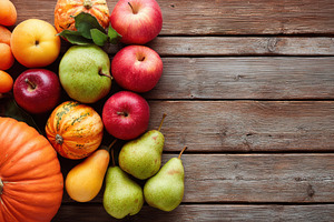 Fresh autumn fruits and vegetables on wooden table, a Food & Drink Photo by AlyaAnd