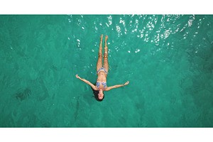 Woman floating on back in turquoise, a Person Photo by Goinyk