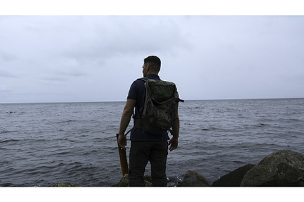 Man walks on stone coast on, a Person Photo by Media Whale Stock