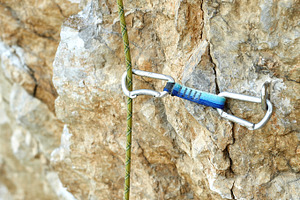 climbing quickdraw fixed on jumper on the cliff and the rope. climbing equipment