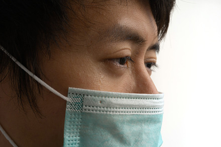 A close-up sad Asian man eyes with medical face mask isolated on, a Person Photo by Tampatra