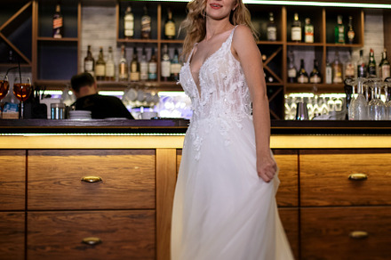 blonde bride in a bar near with a wedding bouquet, a Person Photo by Weddings, People, Travel
