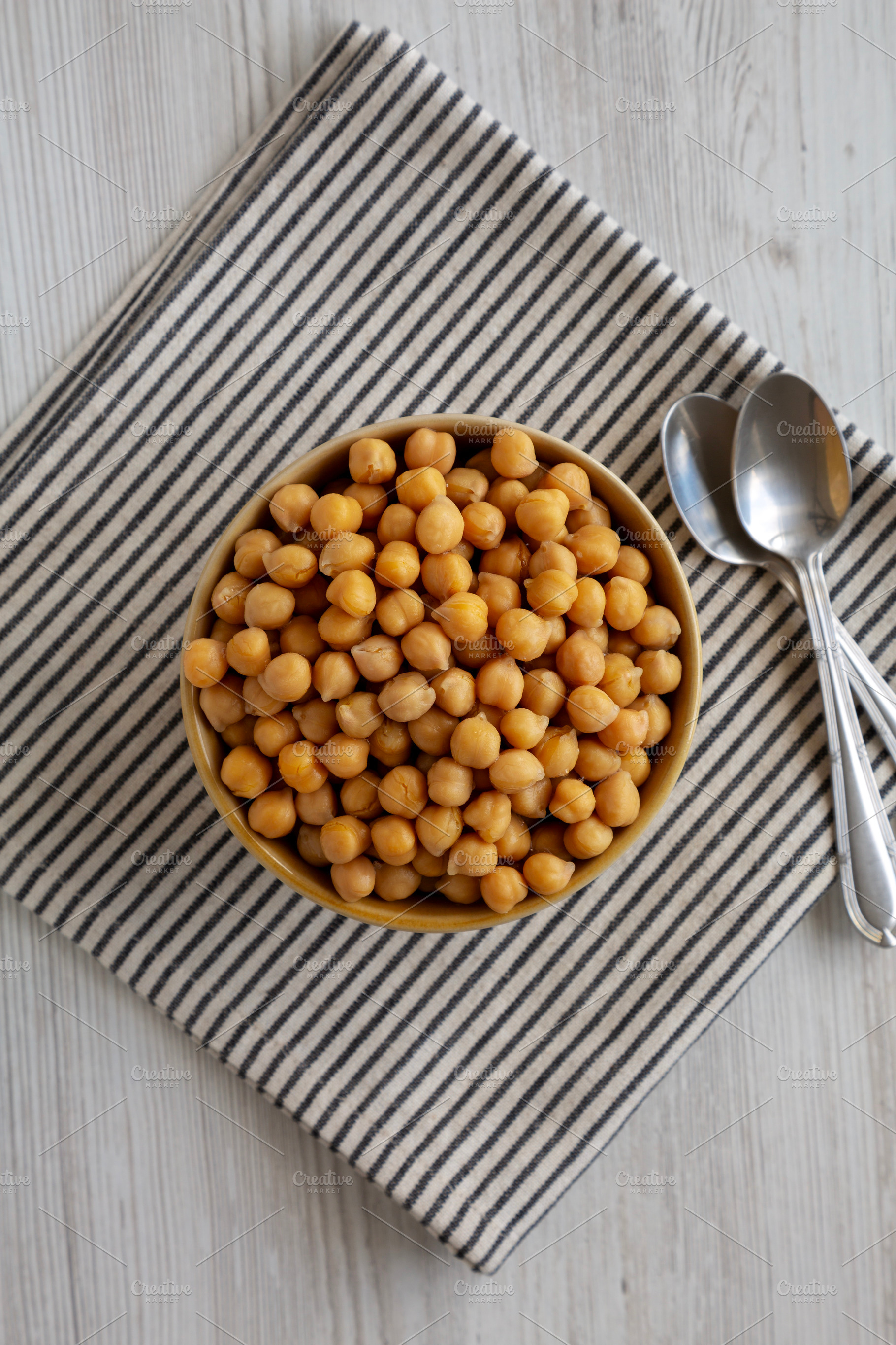 Organic Raw Canned Chickpeas in a Bowl, top view. Flat lay, over, a Food & Drink Photo by LiudmylaChuhunova