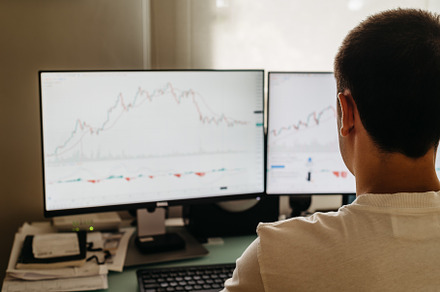 Successful young trader in casual wear working with charts and market reports a, a Person Photo by Architect´s eye