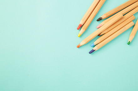 Colorful pencils on pastel pale blue, a Background Photo by 1981 Rustic studio kan