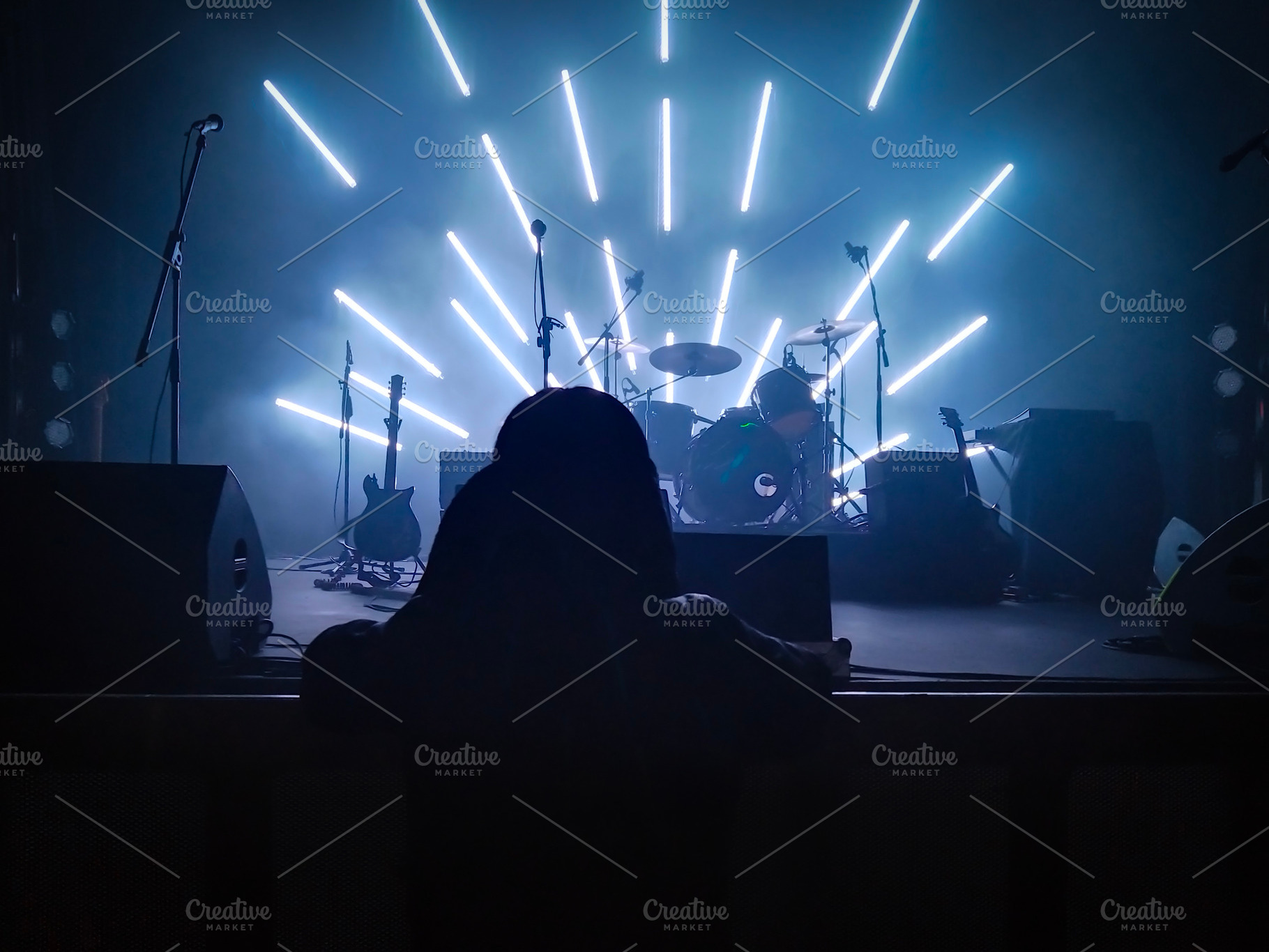 Rock band instruments on stage with radial light beams, a Sports & Recreation Photo by DanFLCreativo